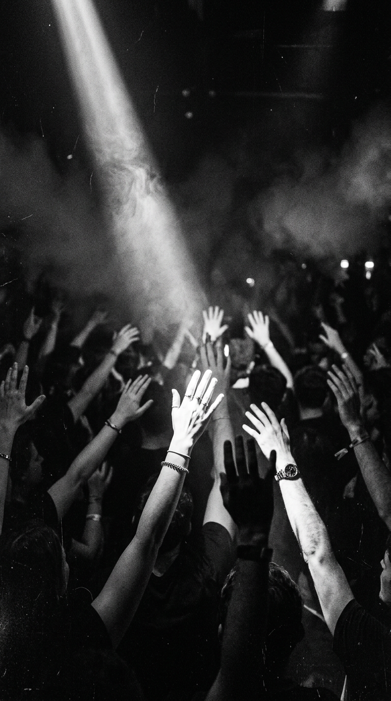 Hands raised in a smoky room
